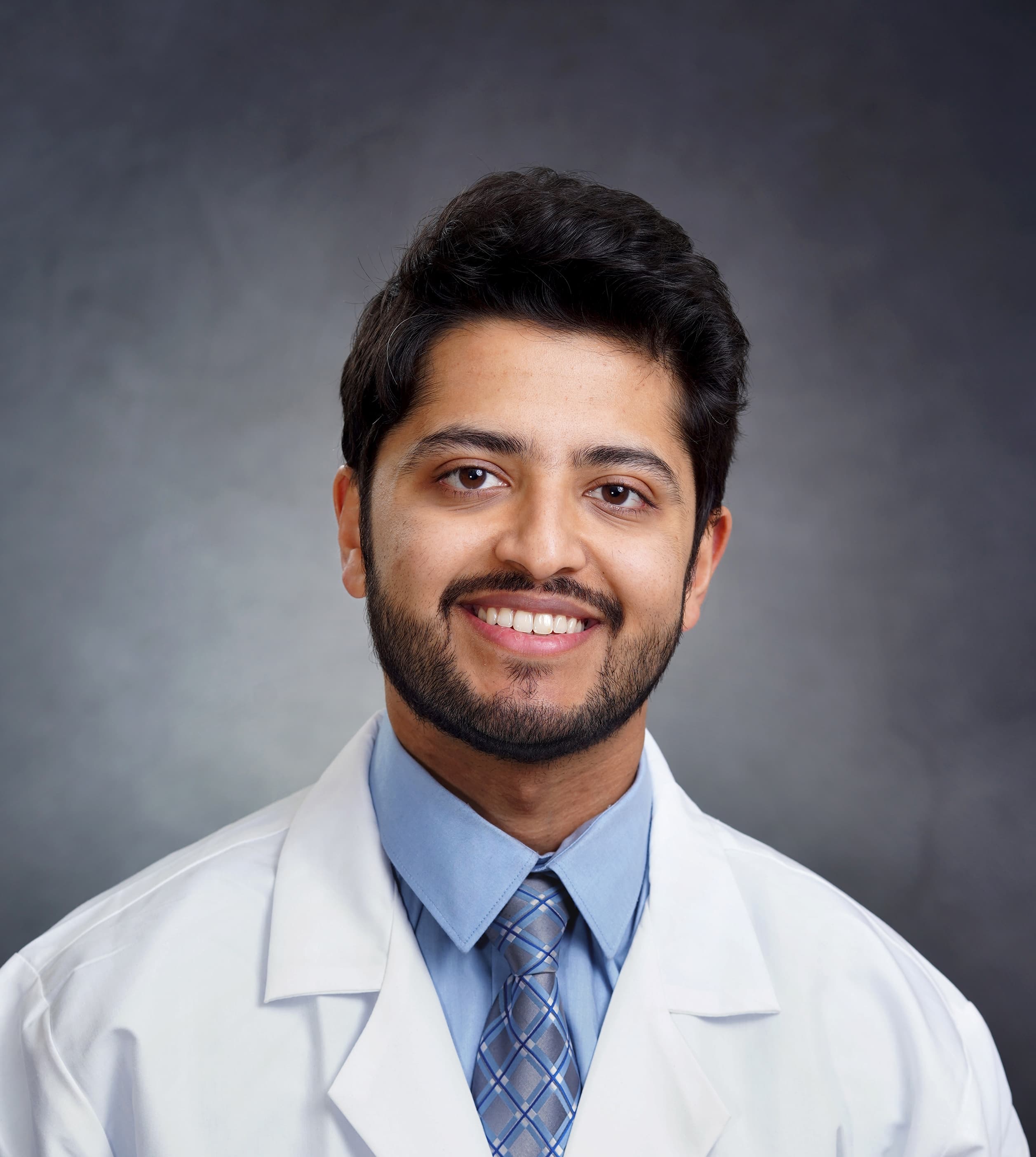 Dr. Meet Parikh wearing a white coat